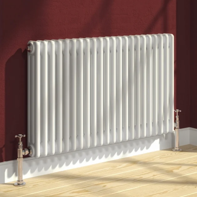 A traditional white Reina Colona multi-column horizontal mild steel radiator mounted on a deep burgundy wall.