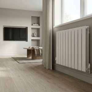 White flat panel double horizontal radiator installed in a modern living room with neutral décor, light wood floors, and large windows
